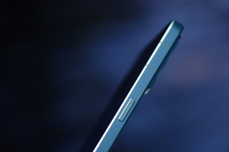 Close-up of a modern smartphone on a dark blue background.のeditorial素材