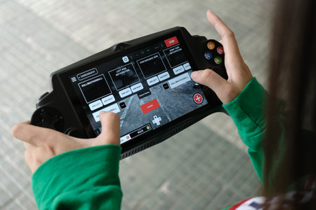 Woman playing video game on tablet indoors, closeup. Space for textのeditorial素材