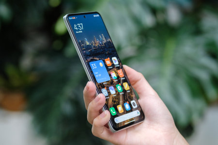 Female hand holding iPhone X with Instagram application on the screen. Instagram is a photo-sharing social networking service.のeditorial素材
