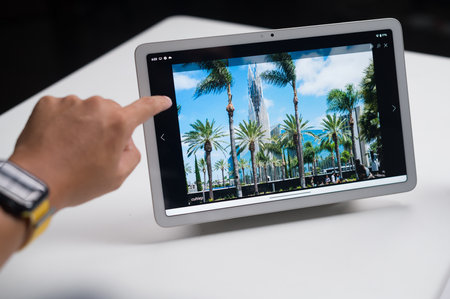 Man using tablet in the office. All screen graphics are made up.のeditorial素材