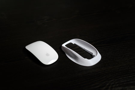 Wireless computer mouse on a dark wooden background. Selective focus.のeditorial素材