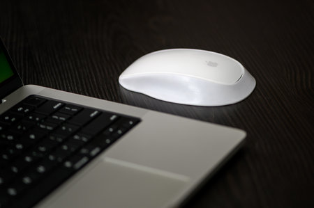 Laptop and mouse on the wooden table. Close-up.のeditorial素材