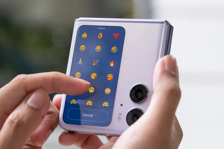 Close-up of a female hand holding a smartphone with social media icons
