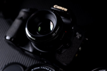 Vintage SLR camera on a black background. Selective focus.のeditorial素材