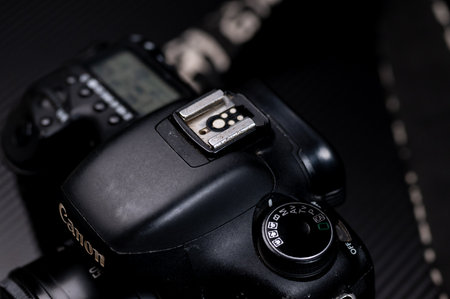 Close up of a black digital SLR camera on a black backgroundのeditorial素材