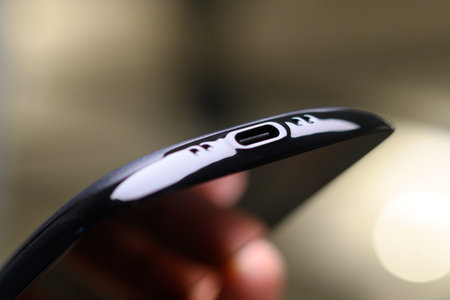 Closeup of a smart phone in a hand with a blurred backgroundのeditorial素材