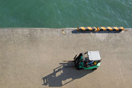 Aerial view of a fork lift manoeuvring in the dock