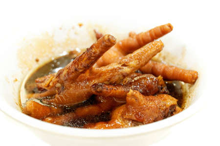 Chicken feet typical Chinese specialty, on white backgroundの写真素材
