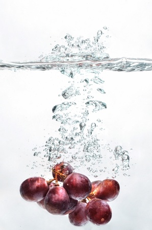 Grape fruit picture taken as they submerged dramatically into a clean water の写真素材
