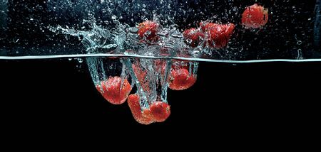 Strawberry fruit picture taken as they submerged dramatically into a clean water の写真素材
