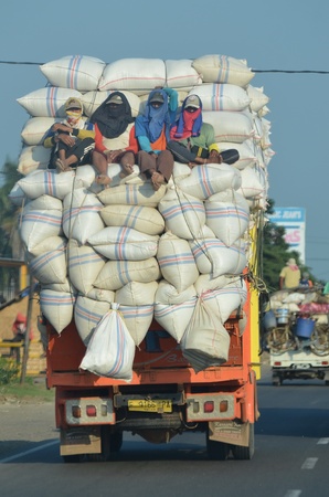 A unique photos of an overloaded truck carrying rice from the mill to the marketのeditorial素材