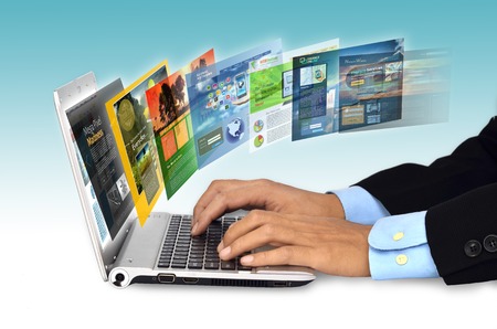 Businessman hand browsing internet websites on his laptopの写真素材