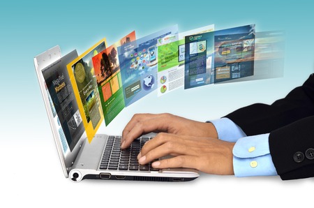 Businessman hand browsing internet websites on his laptop