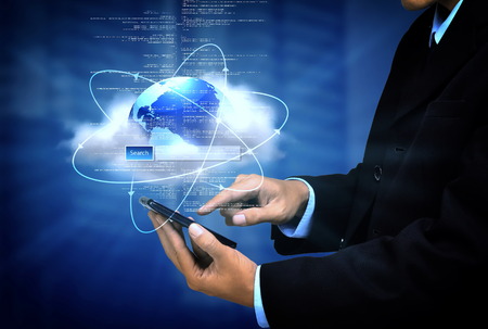 Internet for business conceptual image. Businessman using internet information technology to communicate and access global information.の写真素材