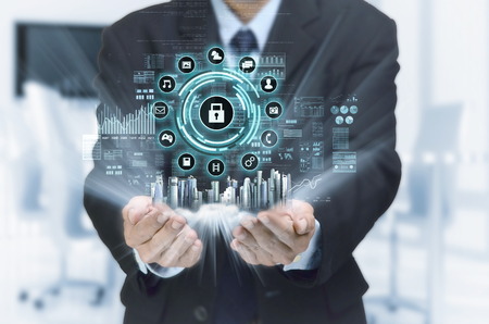 A businessman  show a concept of city and virtual internet business network connection on his hand. A mixed media composed from photo and 3d rendering.の写真素材