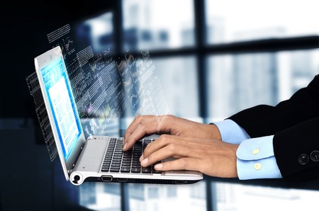 Businessman accessing internet to do his finance and reporting  jobの写真素材