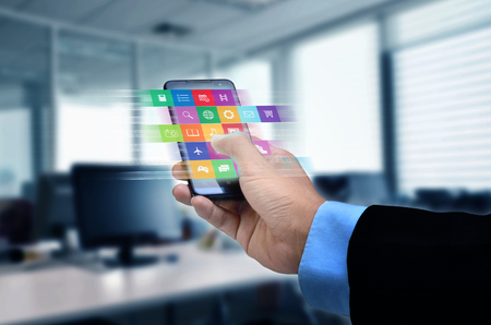 Internet concept. Businessman using a smart phone to browse or use application on lineの写真素材