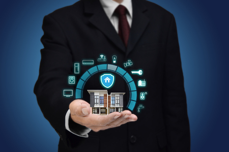smart home and internet of things concept with a businessman show house miniature and application interfaceの写真素材