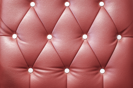 Button on the brown leather sheetの写真素材