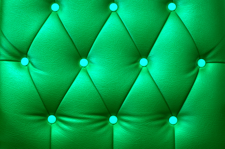 Green leather sheet and buttonsの写真素材
