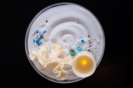 beach decorative with shell and candle on sand tray