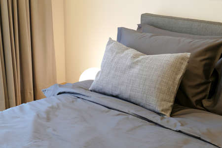 soft pillows on the comfortable  bedの写真素材