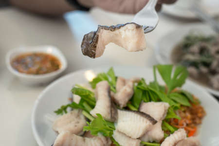 Thai gourmet rustic dishes - Boiled cat fish with celery and spicy dip in the fork