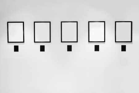 5 Blank white paper canvas photo frame on the white wall for a bulletinの写真素材