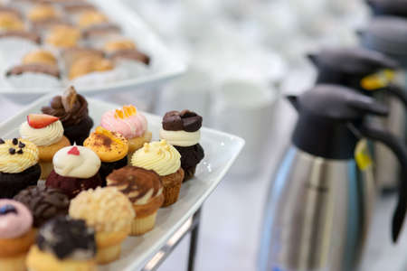 Mini dessert cupcake on white slate platter for tea breakの写真素材