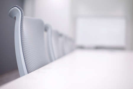 Empty business conference room interior in selective focus on chairの写真素材