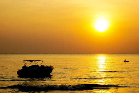 Silhouette yacht  in yellow sunset moment,の写真素材