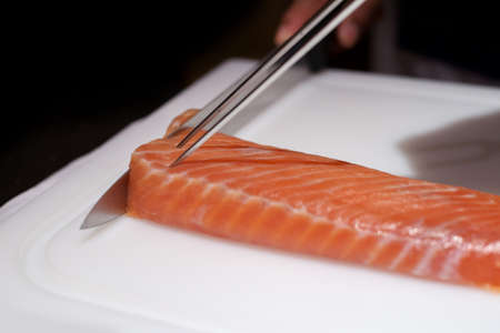chef cutting smoke salmon prepare for customer appetizer