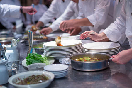 Busy team chefs in commercial  hotel kitchenの写真素材