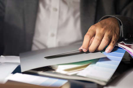 Business man measuring paper with color chart
