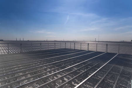 Metal rack over rooftop of  factory  building  under the skyの写真素材