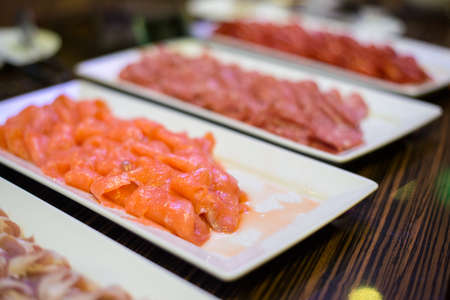 sliced smoked salmon on cold line catering in partyの写真素材