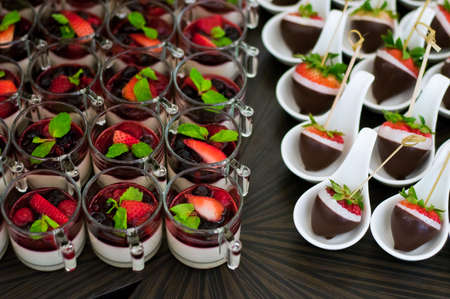 Berries mousse and strawberries chocolate on canape service slate platterの写真素材