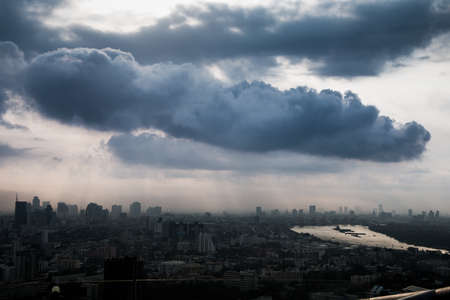 Giant clouds cover over the city and riverの写真素材