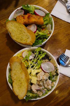 cut breast chicken salad and grill salmon saladの写真素材