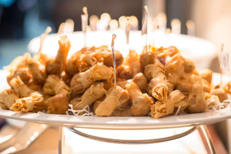 Chinese shrimp spring rolls on platter in hotel reception room