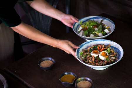 waitress serving healthy japanese saladの写真素材