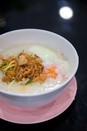egg congee on dark backgroundの写真素材