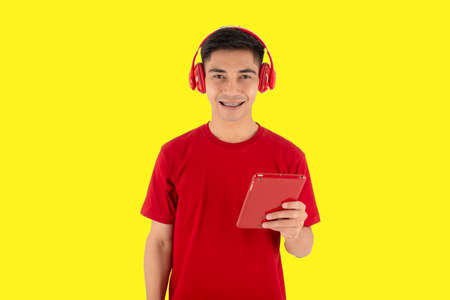 Red t-shirt mad with headset on yellow backgroundの写真素材