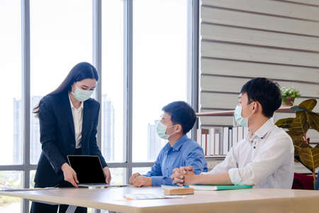 Lady in business dress point her finger on computer screenの写真素材