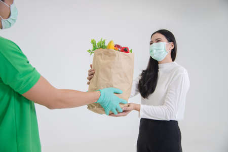 asian lady recieve parcel from postmanの写真素材