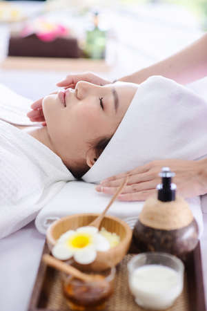 asian lady relaxing in spa with therapist take care her faceの写真素材