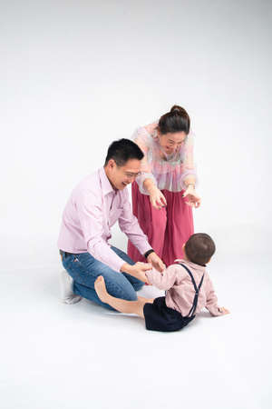 asian parent teasing with their son in white background studio shotの写真素材