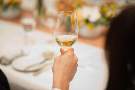 guest hold wine glass in fine dining restaurantの写真素材