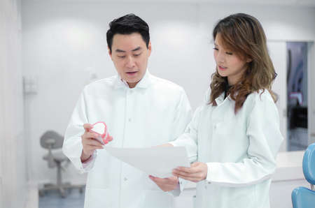 two asian dentist dicussing in clinicの写真素材