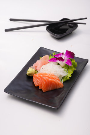 fine sliced salmon prepare on black plateの写真素材